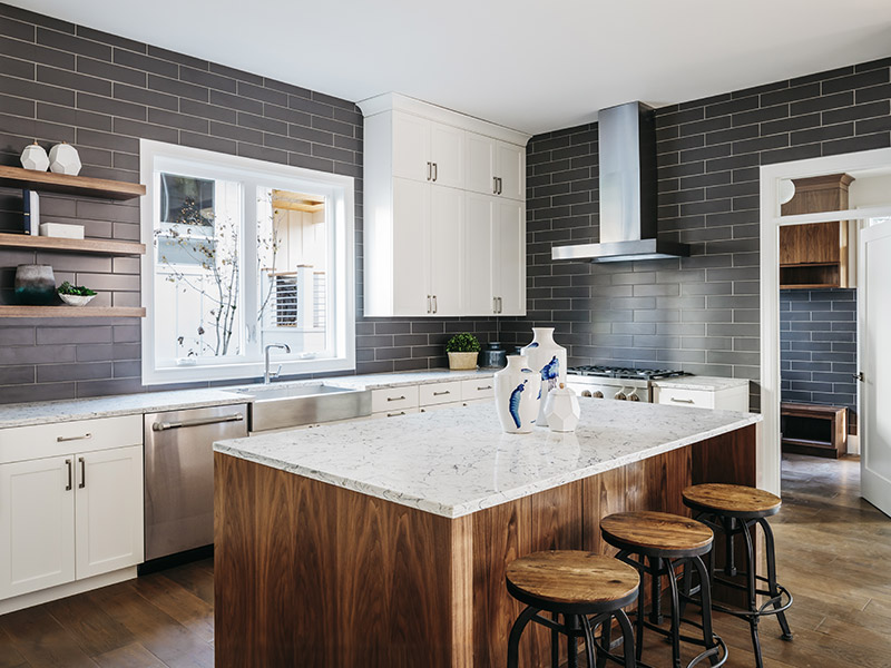kitchen with black tile wall and wood and marble island madison wi